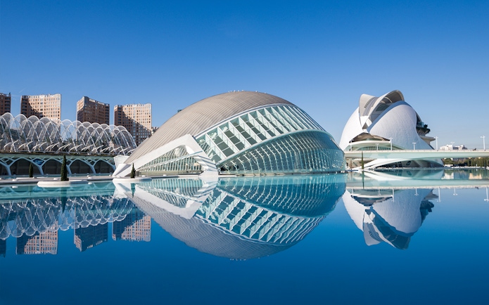 Hemisfèric and Science Museum in Valencia reflected in water.