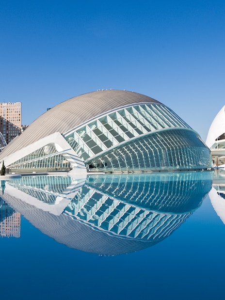 Hemisfèric and Science Museum in Valencia reflected in water.