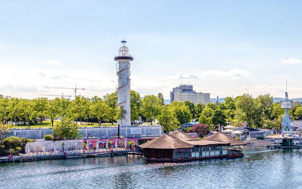 Sunken City Park lighthouse and Danube River on Danube Island, Vienna, Austria.