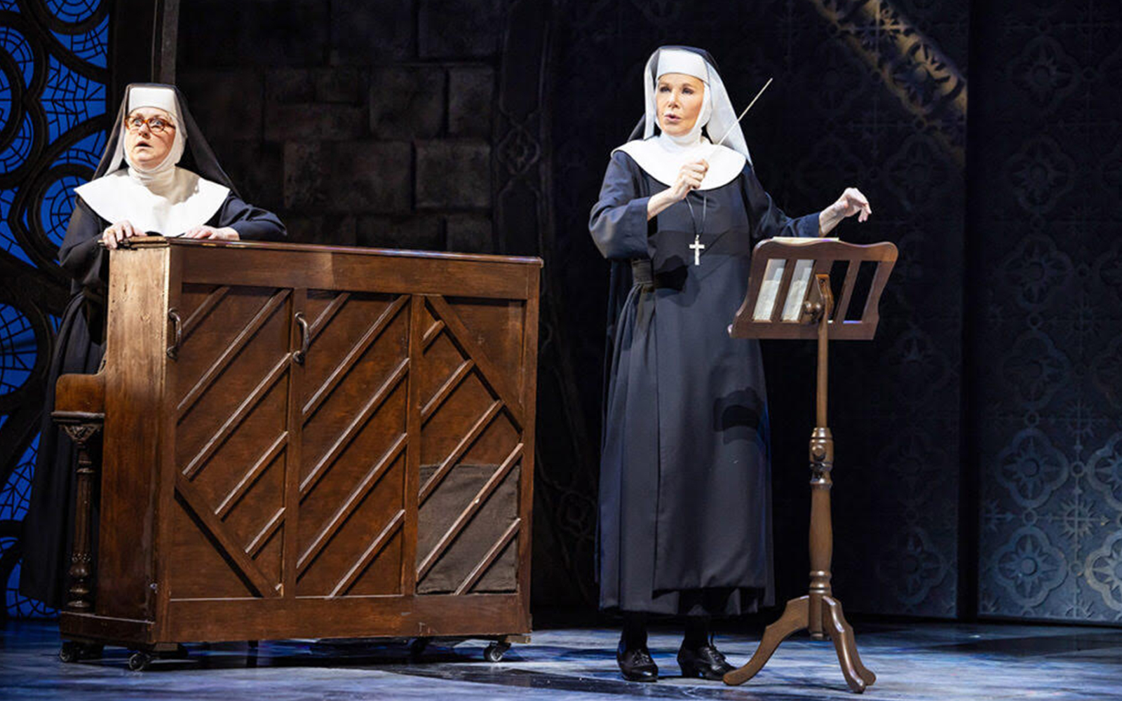Nuns performing a musical scene from Sister Act on stage.