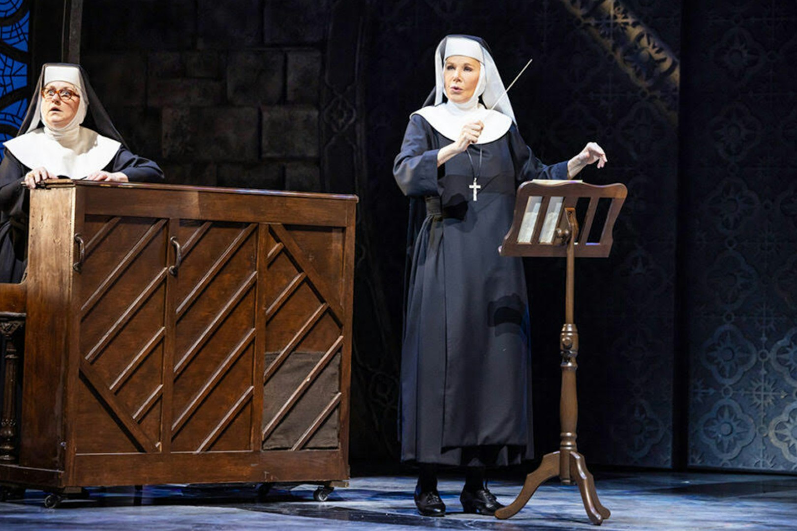 Nuns performing a musical scene from Sister Act on stage.