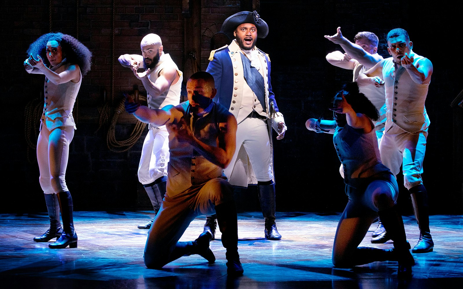 Performers on stage during a scene from the musical Hamilton.
