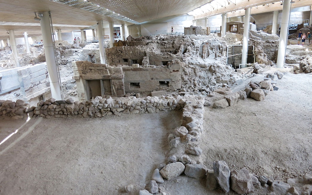 Akrotiri Archaeological Site ruins with ancient stone structures in Santorini, Greece.