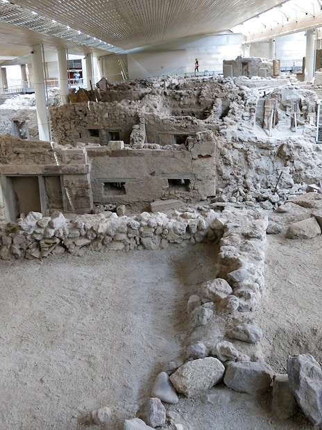 Akrotiri Archaeological Site ruins with ancient stone structures in Santorini, Greece.