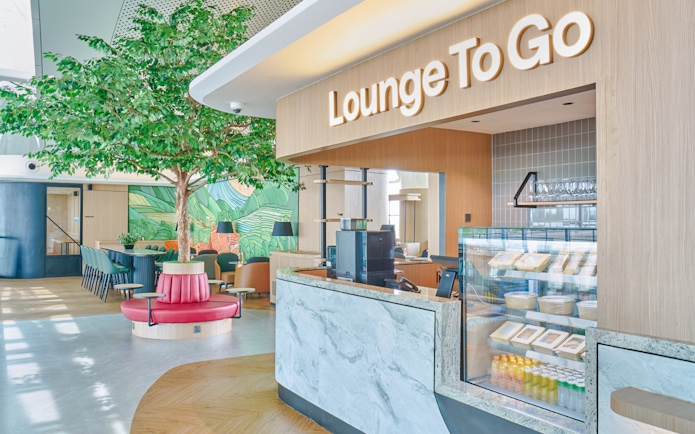 Lounge entrance with seating area and snack counter.