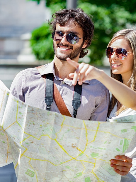 Tourists with a map exploring the Italian Riviera and Monaco.