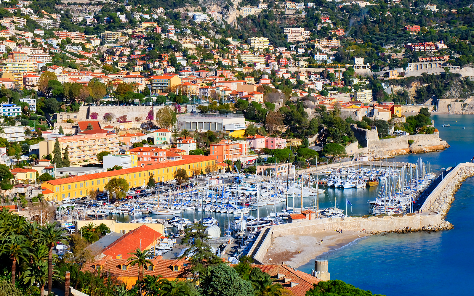 Villefranche sur Mer harbor with colorful buildings and yachts, Nice sightseeing cruise.