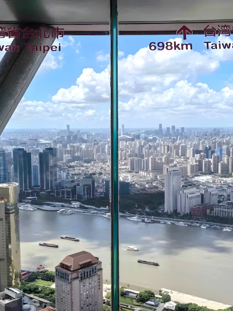Panoramic view of Shanghai skyline from Oriental Pearl Tower observation deck.