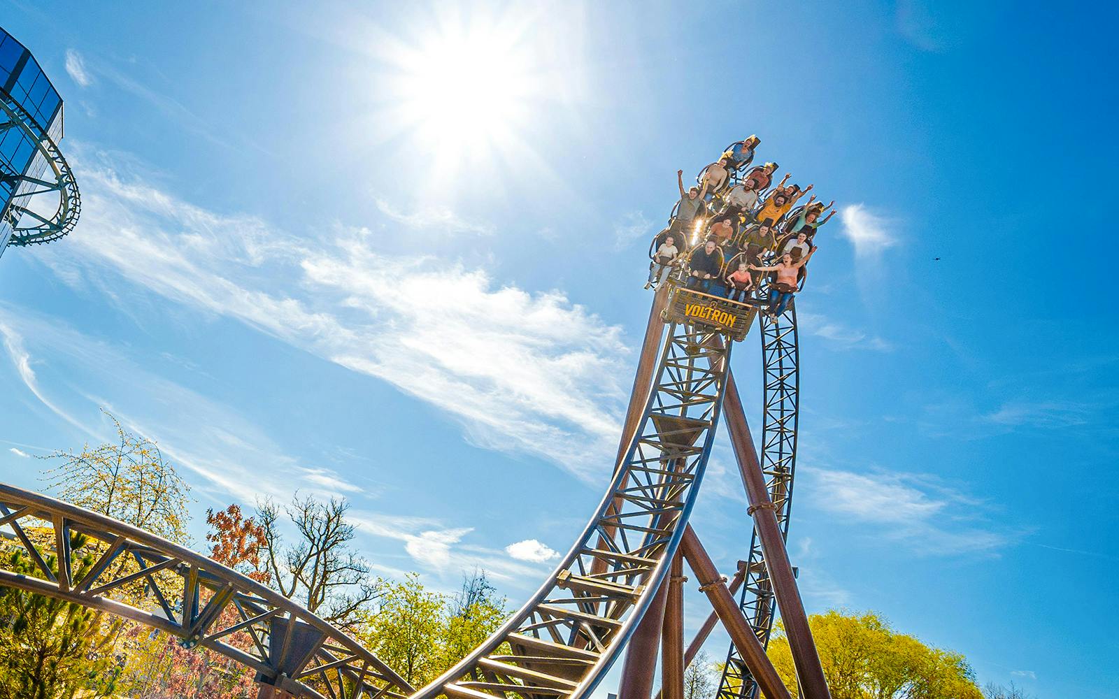 Roller coaster descent at Europa Park under a clear blue sky.