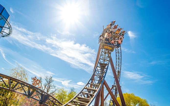 Roller coaster descent at Europa Park under a clear blue sky.
