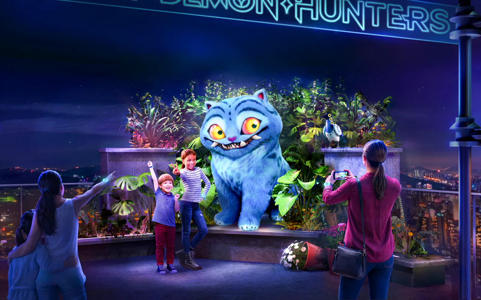 Visitors interacting with a large blue animated creature at Netflix House Philadelphia, Kpop Demon Hunters exhibit.