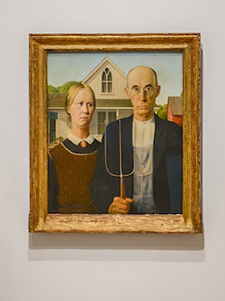Visitors viewing "American Gothic" painting at Whitney Museum exhibit.