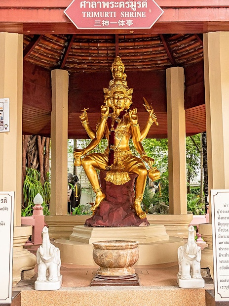 Trimurti Shrine statue with multiple arms in ancient city, Thailand.