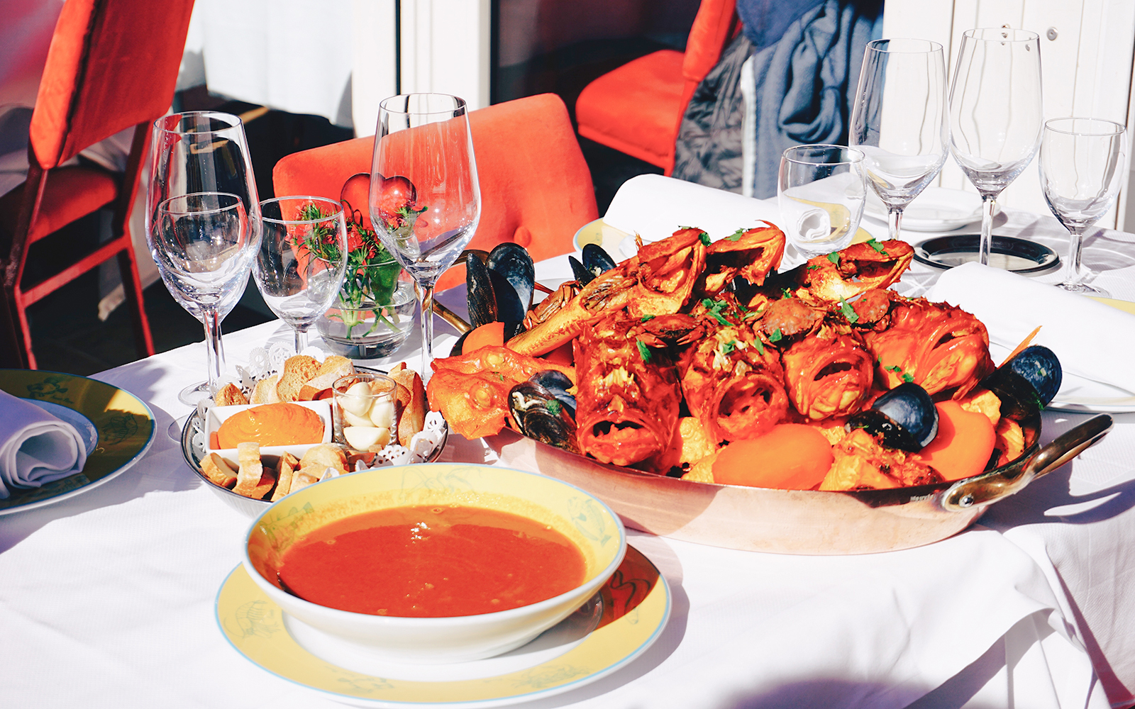 Seafood platter and soup served on a table.