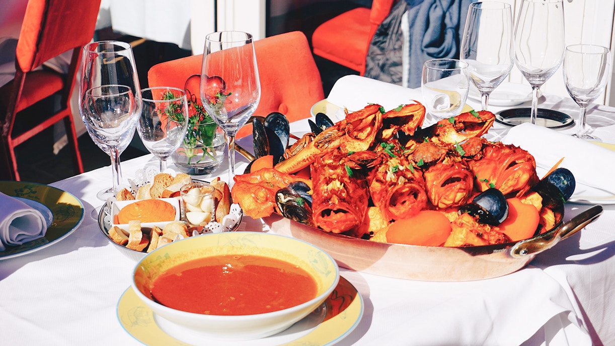 Seafood platter and soup served on a table.