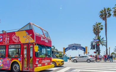 Open-top tour bus near Santa Monica Pier entrance, Los Angeles.