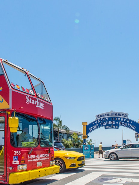 Open-top tour bus near Santa Monica Pier entrance, Los Angeles.