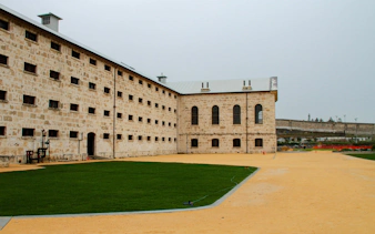 Historic Fremantle Prison courtyard with limestone walls, Western Australia.