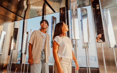 Visitors exploring the mirrored walls at Edge NYC Observation Deck.