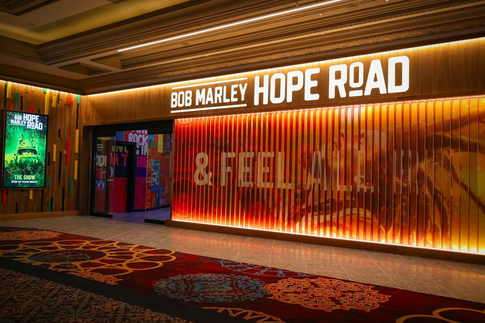 Entrance to Bob Marley The Show in Vegas, featuring vibrant signage and colorful decor.