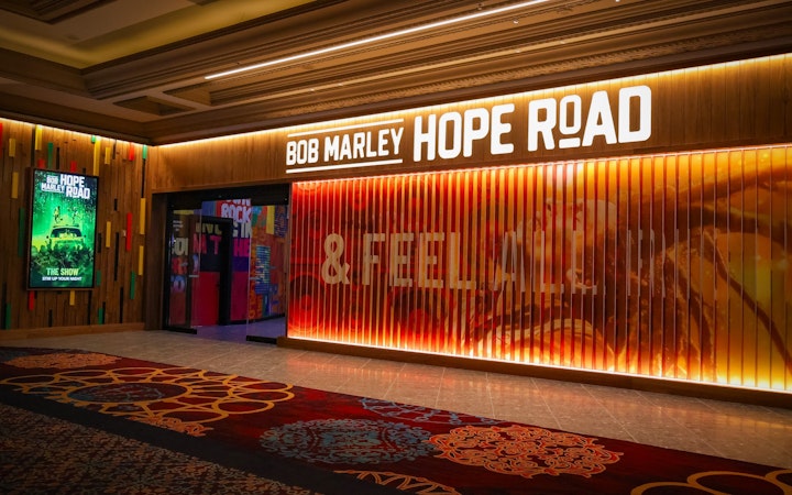 Entrance to Bob Marley The Show in Vegas, featuring vibrant signage and colorful decor.
