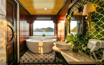 Luxurious bathroom with a bathtub and sea view on Du Junior Cabin, Ha Long Bay cruise.