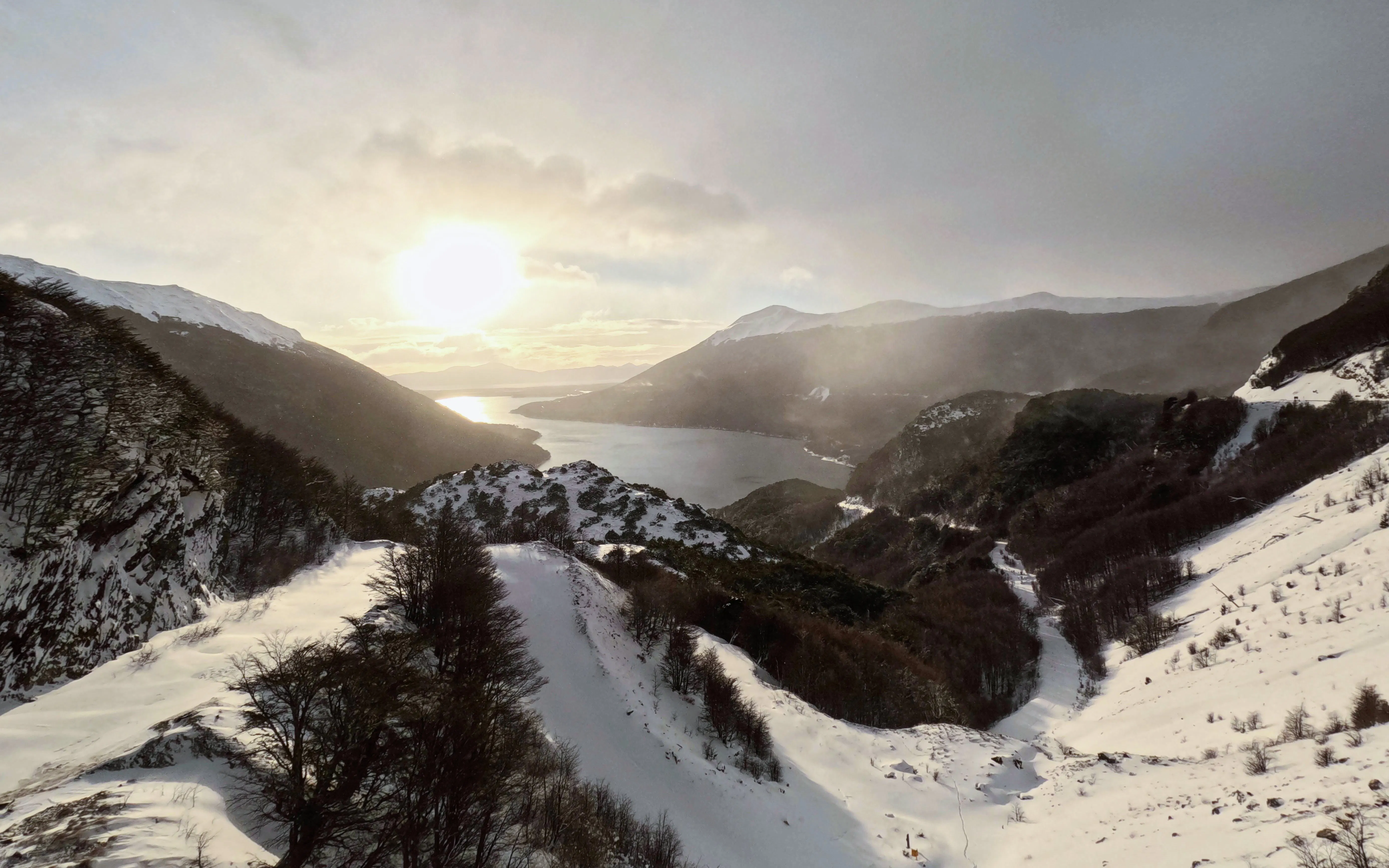 Snowy landscape at Paso Garibaldi viewpoint overlooking mountains and lake in Ushuaia, Argentina.