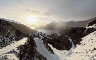 Snowy landscape at Paso Garibaldi viewpoint overlooking mountains and lake in Ushuaia, Argentina.