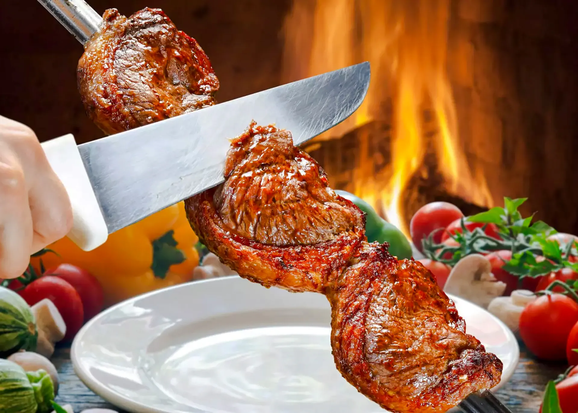 Slicing grilled meat at a Brazilian steakhouse in Rio de Janeiro.