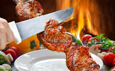 Slicing grilled meat at a Brazilian steakhouse in Rio de Janeiro.
