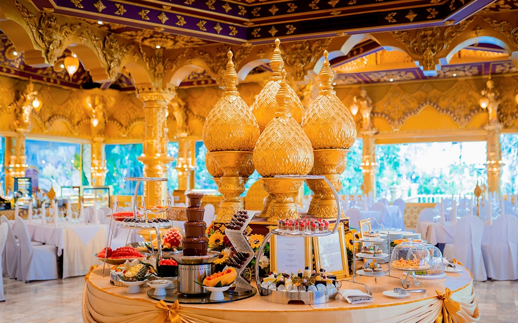 Phuket Fantasea buffet with ornate golden decor and dessert display.
