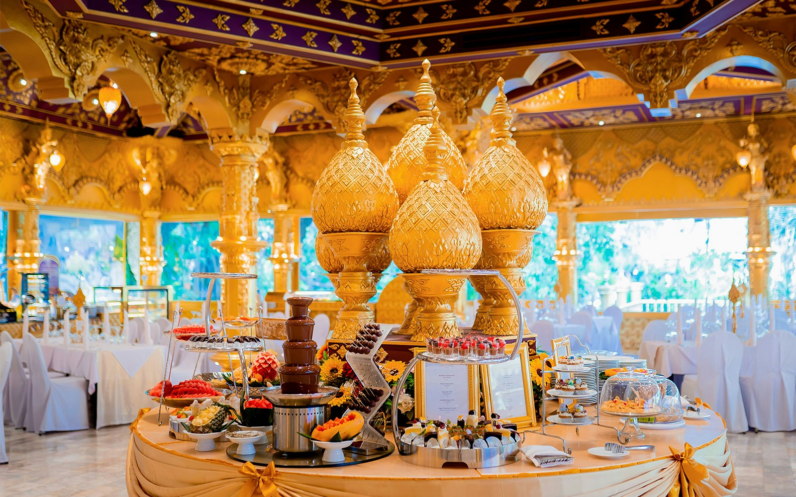 Phuket Fantasea buffet with ornate golden decor and dessert display.