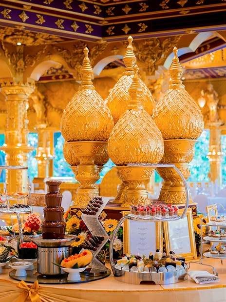 Phuket Fantasea buffet with ornate golden decor and dessert display.