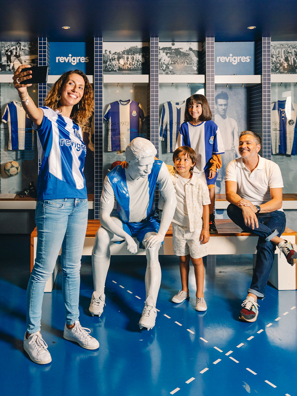Visitors taking a selfie with a statue at FC Porto Museum, Porto, Portugal.