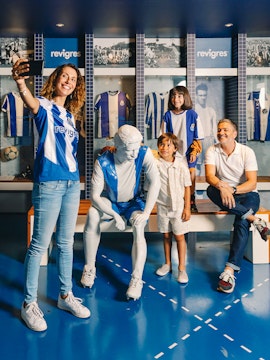 Visitors taking a selfie with a statue at FC Porto Museum, Porto, Portugal.