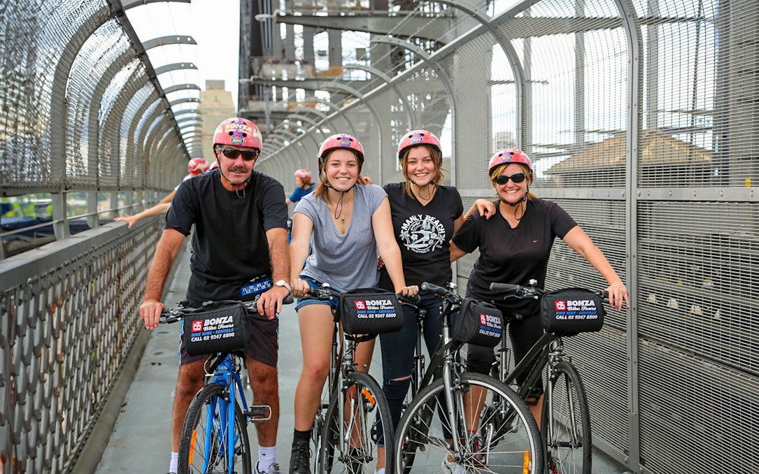 Group enjoying Bonza Bike Tours on a bridge in Sydney.