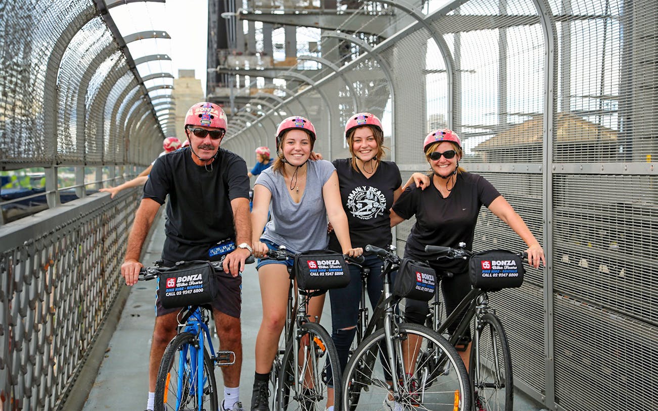Group enjoying Bonza Bike Tours on a bridge in Sydney.