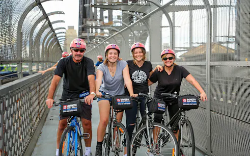 Group enjoying Bonza Bike Tours on a bridge in Sydney.