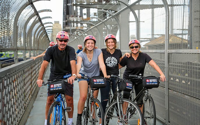 Group enjoying Bonza Bike Tours on a bridge in Sydney.
