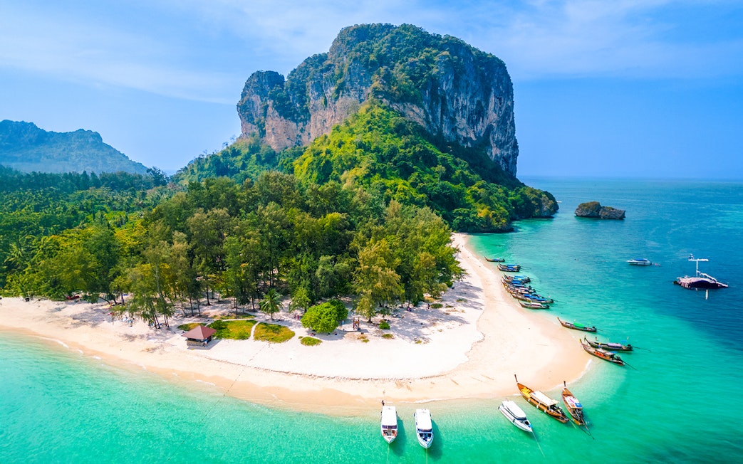 Aerial view of Ko Poda Island with sandy beach and boats in turquoise water, Thailand.