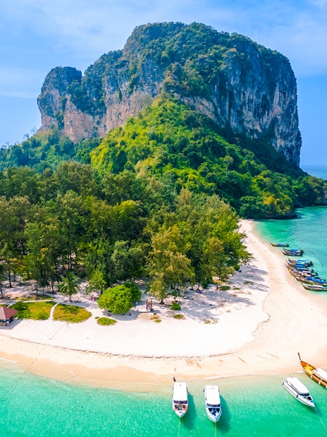 Aerial view of Ko Poda Island with sandy beach and boats in turquoise water, Thailand.
