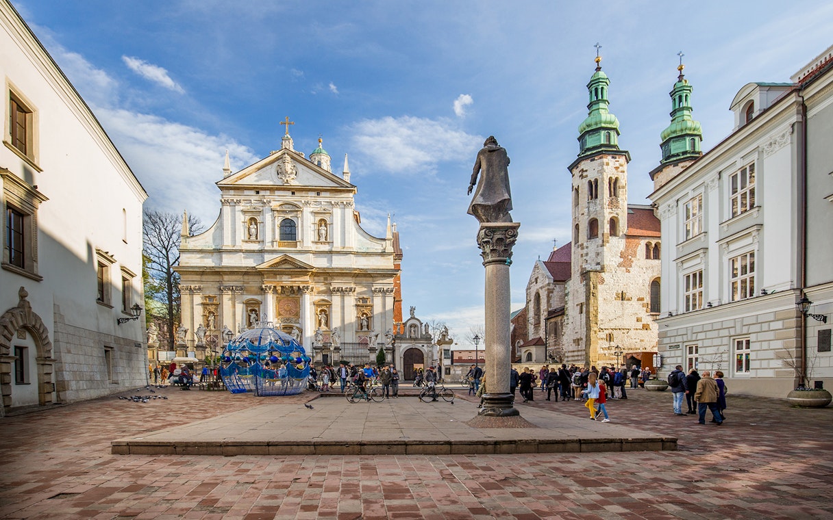 Tourists exploring Krakow's old town near Saints Peter and Paul Church.