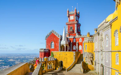 Pena Palace in Sintra with colorful towers and panoramic view of the landscape.