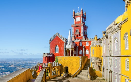 Pena Palace in Sintra with colorful towers and panoramic view of the landscape.