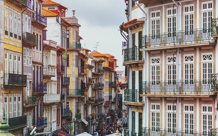 Colorful buildings on a narrow street in Porto near Misericórdia Museum and Church.