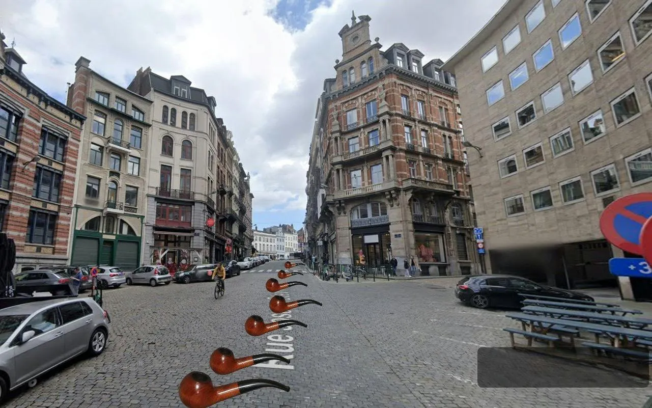 Cobbled street in Brussels with historic buildings, part of a self-guided city exploration game.