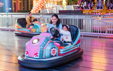 Family enjoying bumper cars at Genting Skytropolis Indoor Theme Park.