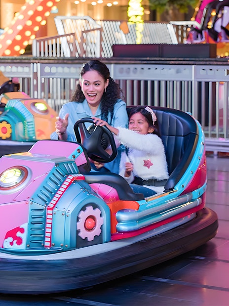 Family enjoying bumper cars at Genting Skytropolis Indoor Theme Park.