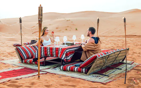 Desert dining setup for Dubai private luxury family dinner and camel trekking experience.