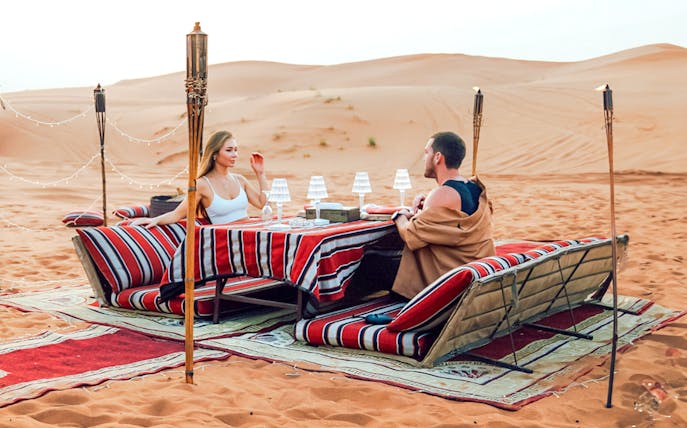 Desert dining setup for Dubai private luxury family dinner and camel trekking experience.